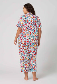 A Lady Wearing Plus Size Ottoman Bloom Short Sleeve Classic Stretch Jersey Cropped Pj Set in a back view pose