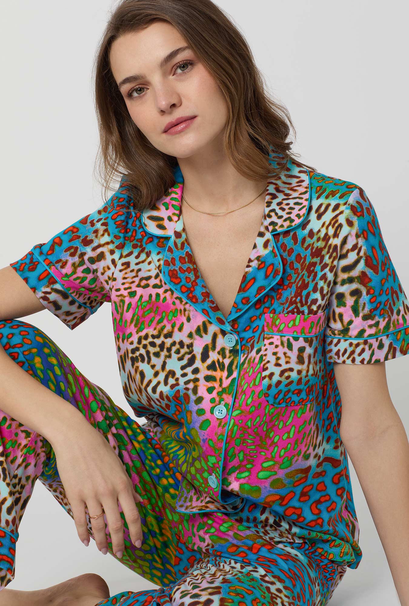 A lady wearing BedHead x Trina Turk Spray Leopard Short Sleeve Classic Stretch Jersey Cropped Pj Set