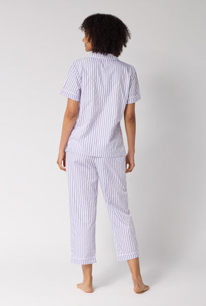 A Lady Wearing Blue Signature Stripe Short Sleeve Classic Woven Cotton Sateen Cropped Pj Set in a back view pose while looking to the side