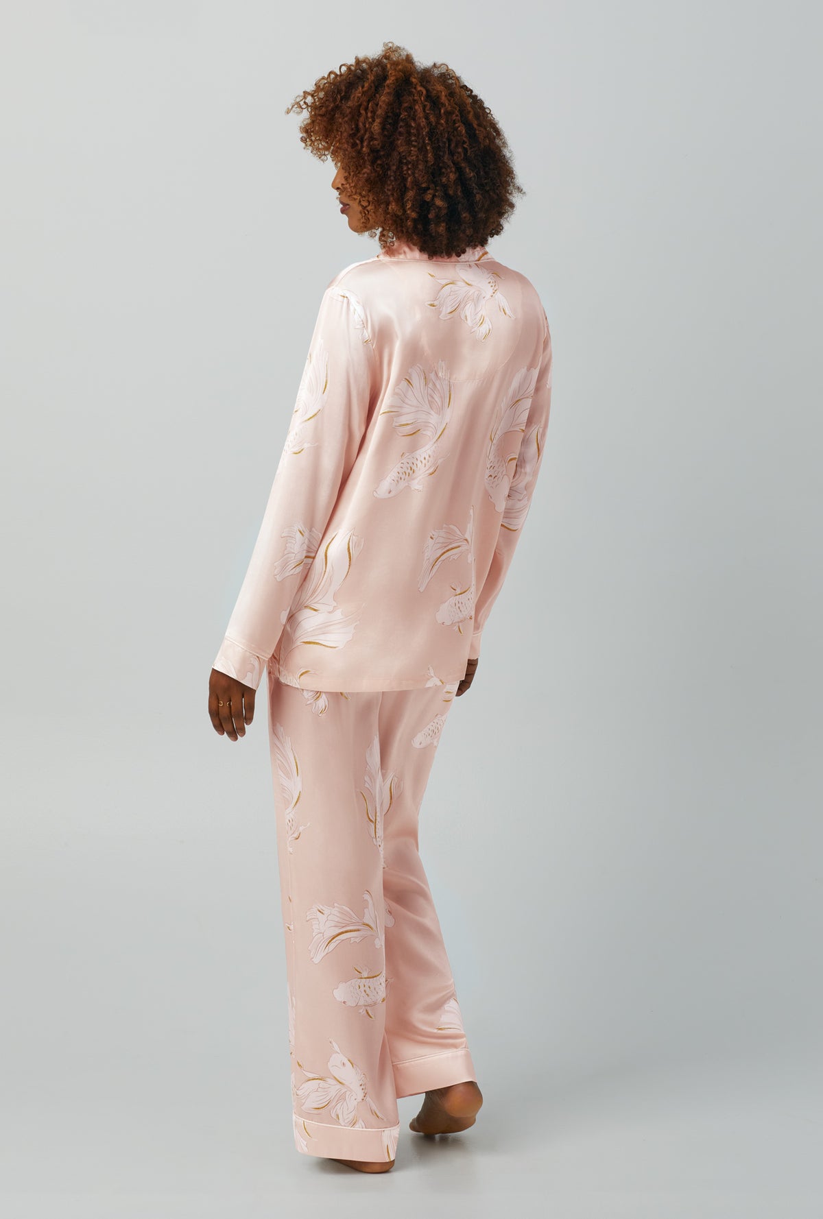 A lady wearing Long Sleeve Classic Washable Silk PJ Set with koi pond print