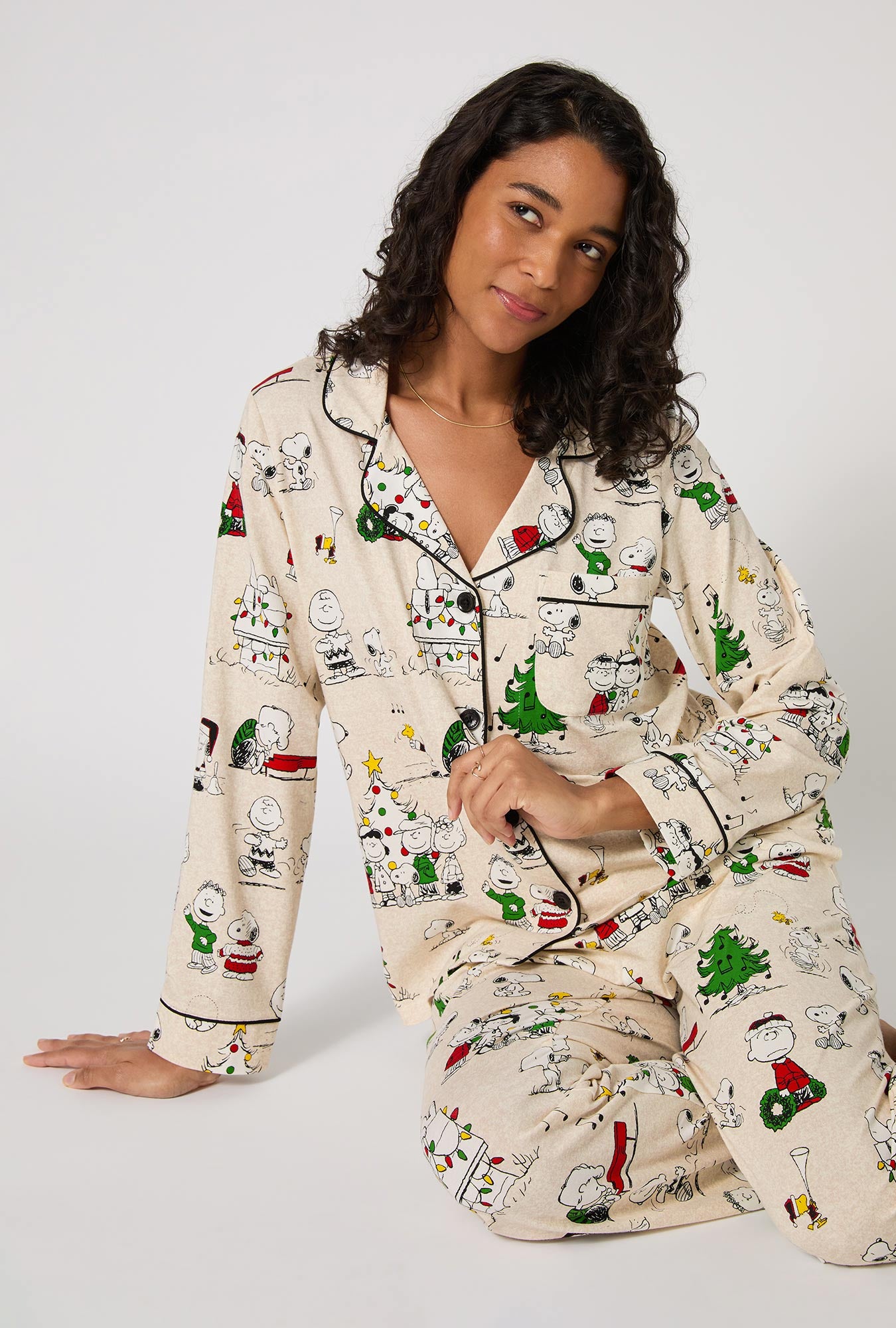 A lady wearing Peanuts® Celebration Long Sleeve Classic Stretch Jersey Pj Set