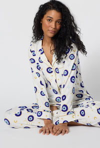 A Women Wearing Eyeconic Long Sleeve Classic Stretch Jersey Pj Set in a sitting close up view pose