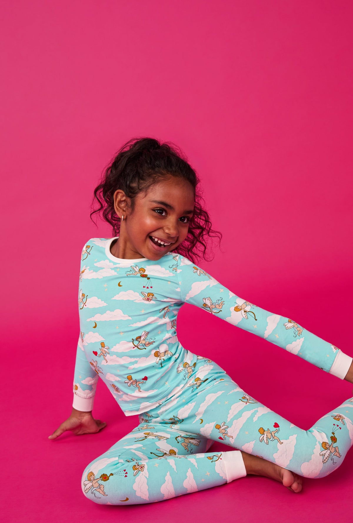 A girl wearing Cheeky Cupid Long Sleeve Stretch Jersey Kids Pj Set