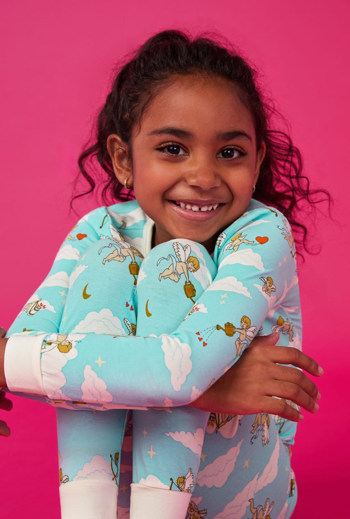 A girl wearing Cheeky Cupid Long Sleeve Stretch Jersey Kids Pj Set
