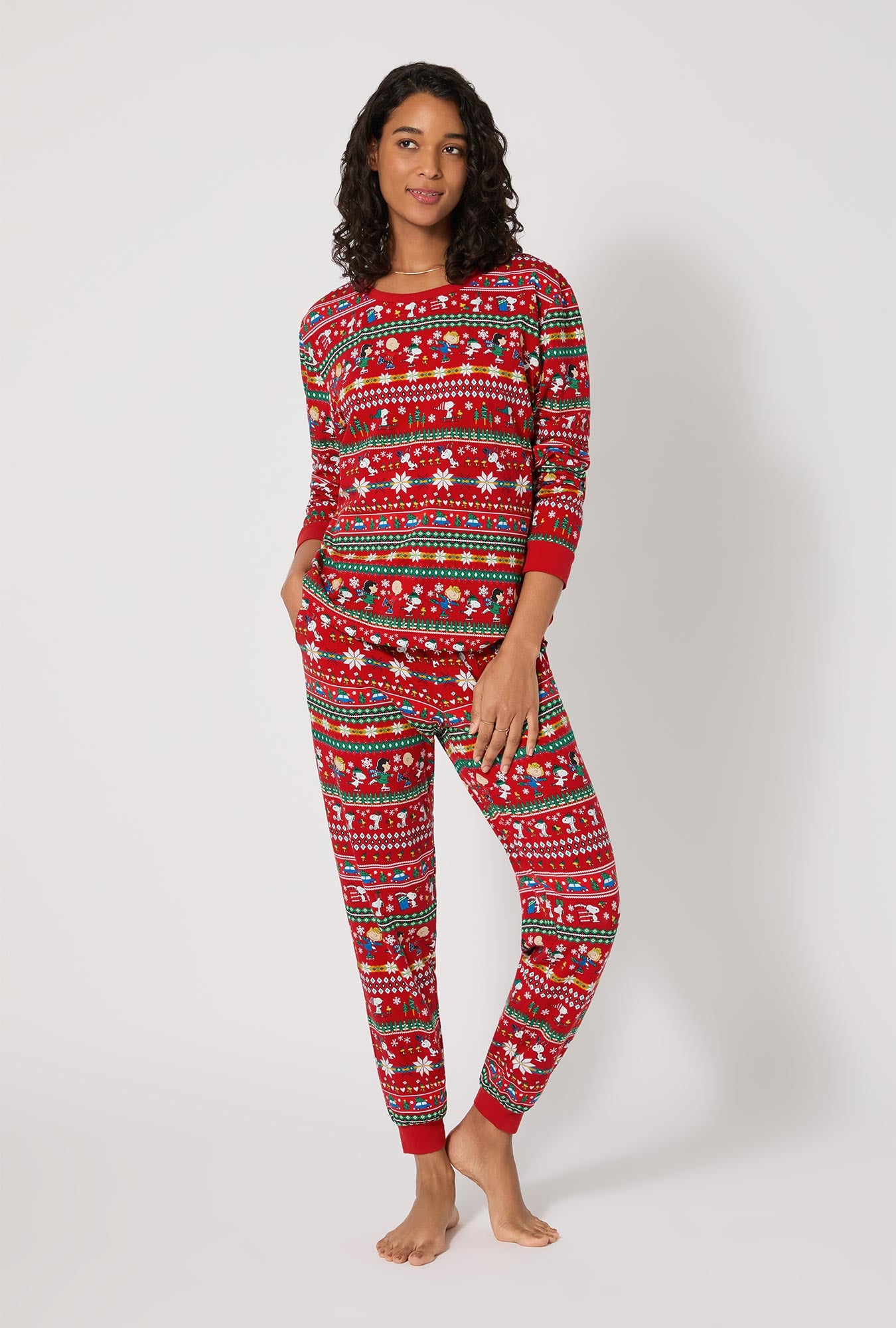A lady wearing Peanuts®  Winter Fairisle Long Sleeve Pullover Crew And Jogger Stretch Jersey Pj Set