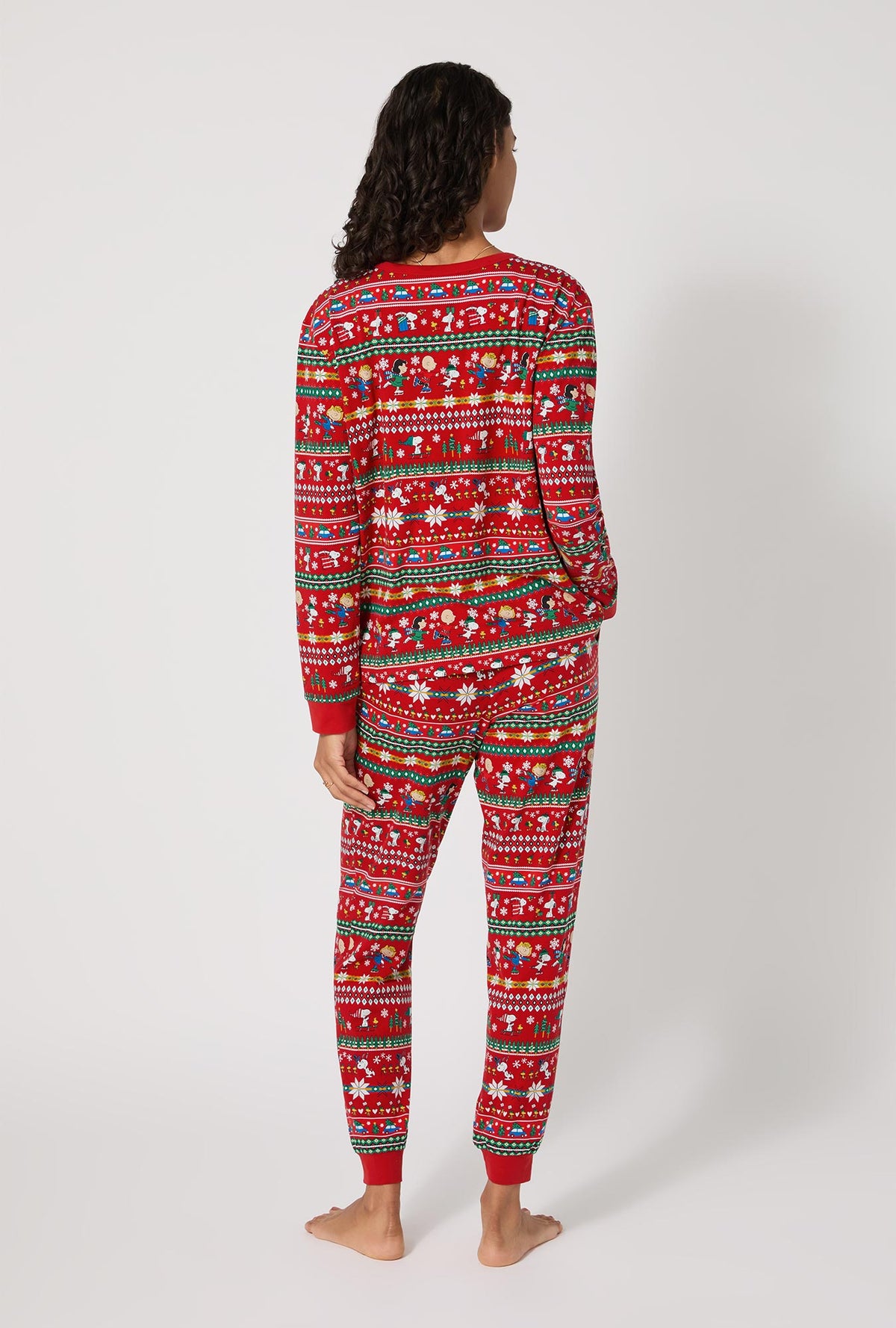 A lady wearing Peanuts®  Winter Fairisle Long Sleeve Pullover Crew And Jogger Stretch Jersey Pj Set