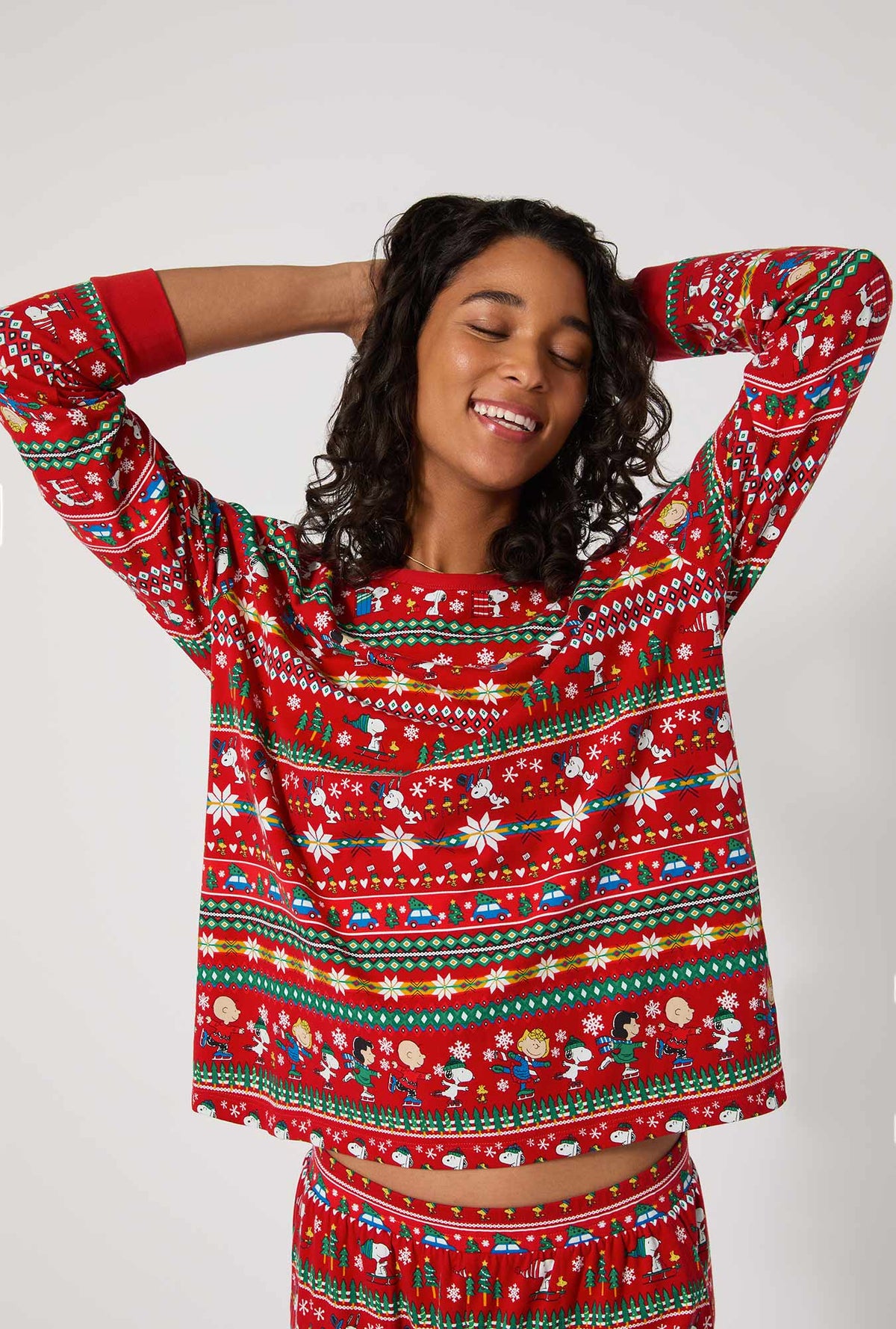 A lady wearing Peanuts®  Winter Fairisle Long Sleeve Pullover Crew And Jogger Stretch Jersey Pj Set