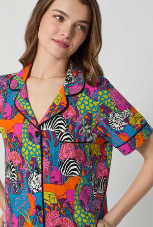 A lady wearing BedHead x Trina Turk Jungle Short Sleeve Classic Shorty Stretch Jersey Pj Set