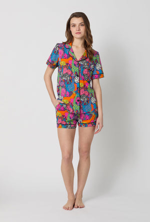 A lady wearing BedHead x Trina Turk Jungle Short Sleeve Classic Shorty Stretch Jersey Pj Set