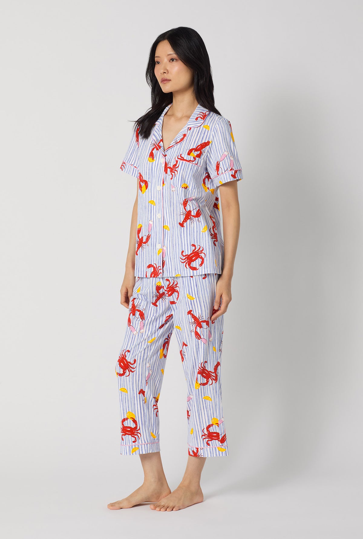 A lady wearing Coastal Feast Short Sleeve Classic Stretch Jersey Cropped Pj Set looking side
