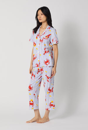 A lady wearing Coastal Feast Short Sleeve Classic Stretch Jersey Cropped Pj Set looking side