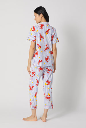 A lady wearing Coastal Feast Short Sleeve Classic Stretch Jersey Cropped Pj Set back view