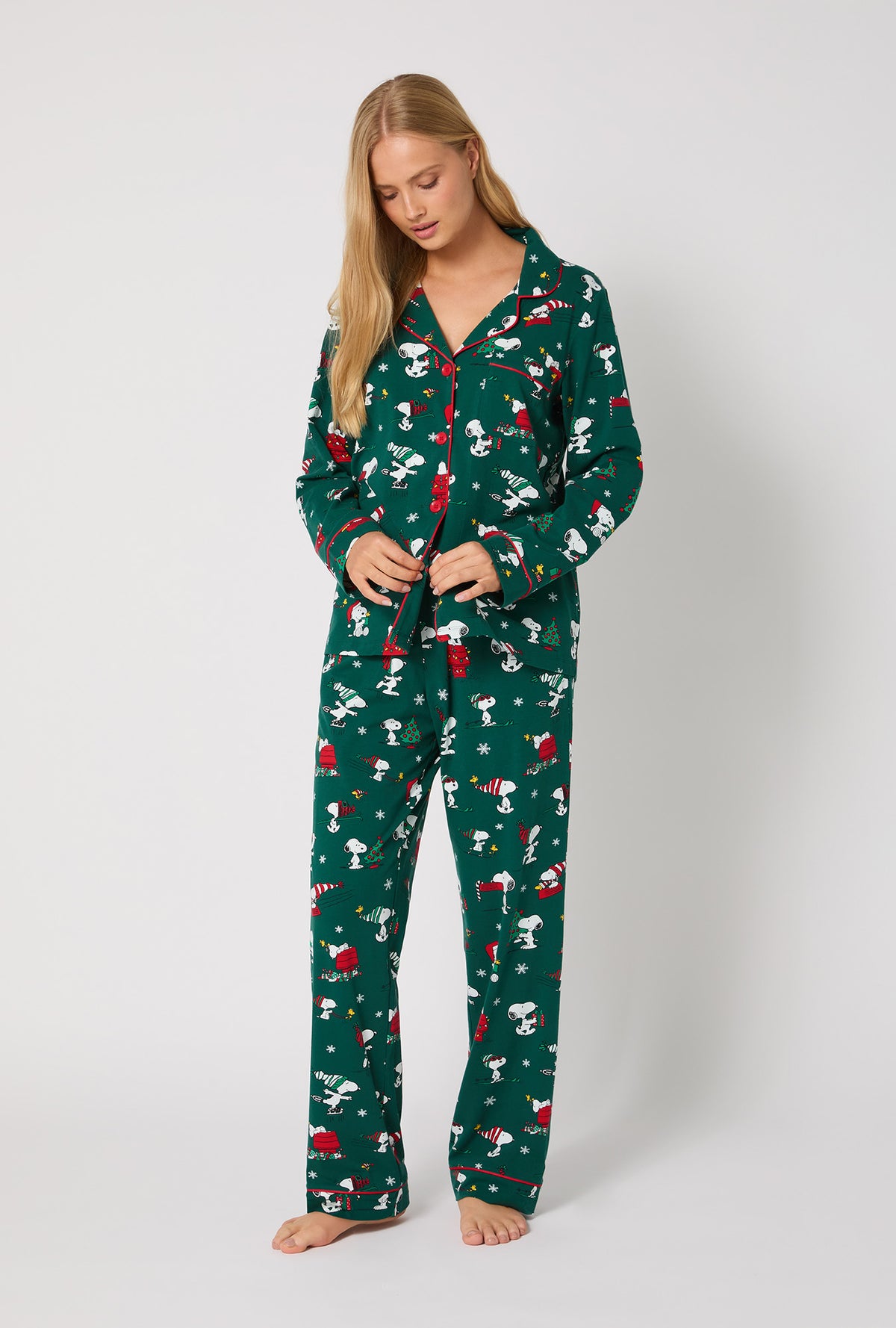 A lady wearing ®Snoopy's Holiday Fun Long Sleeve Classic Stretch Jersey Pj Set