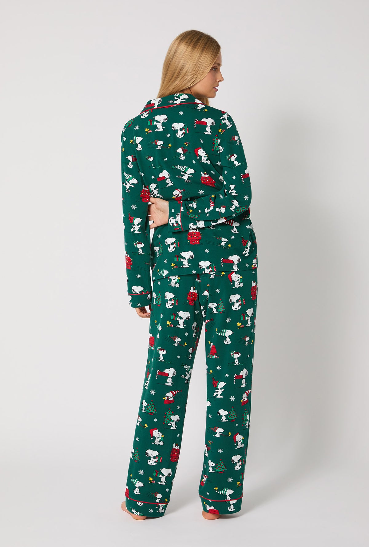 A lady wearing ®Snoopy's Holiday Fun Long Sleeve Classic Stretch Jersey Pj Set