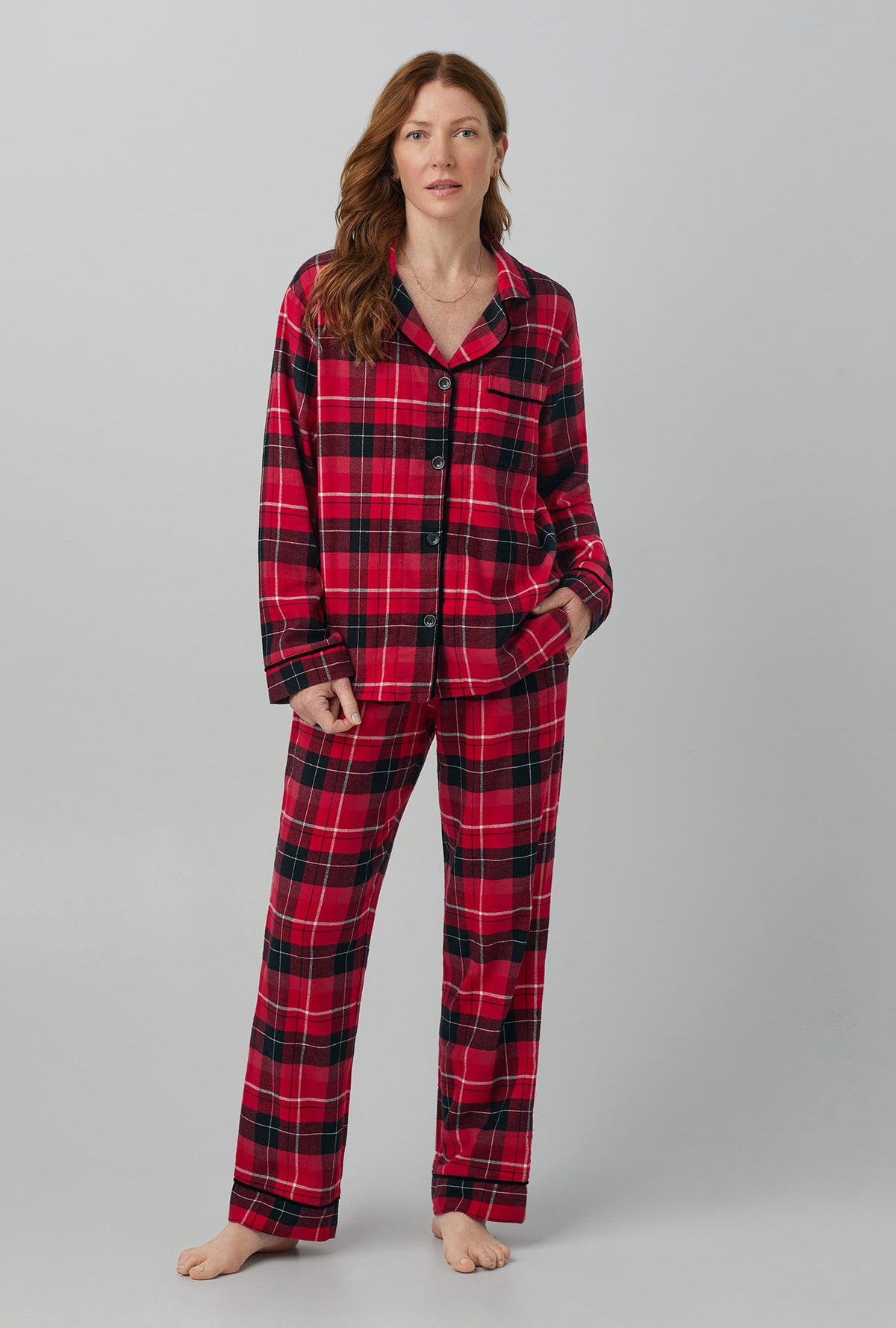 A lady wearing red long sleeve clasic woven cotton flannel pj set with nicholas plaid print.
