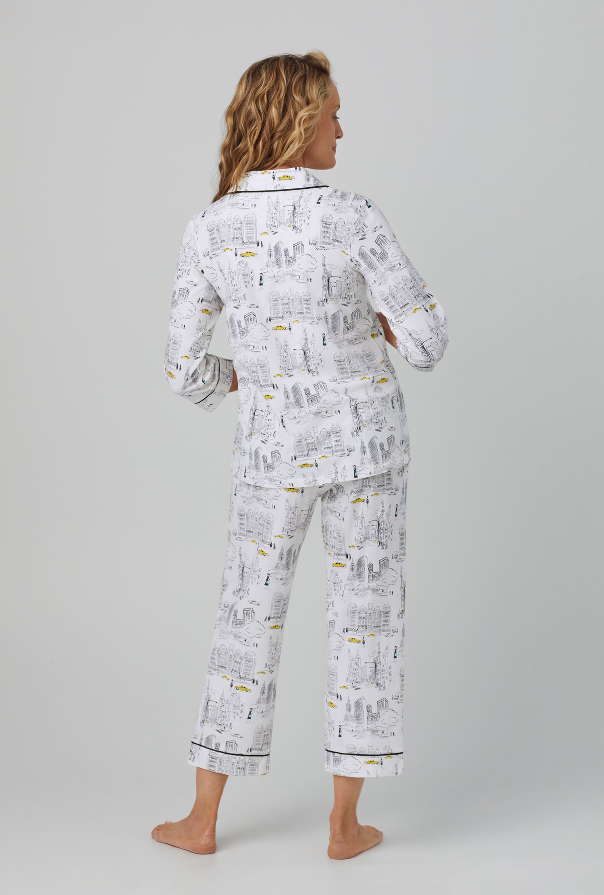 A lady wearing white  3/4 Sleeve Classic Stretch Jersey Cropped PJ Set with City That Never Sleeps  print