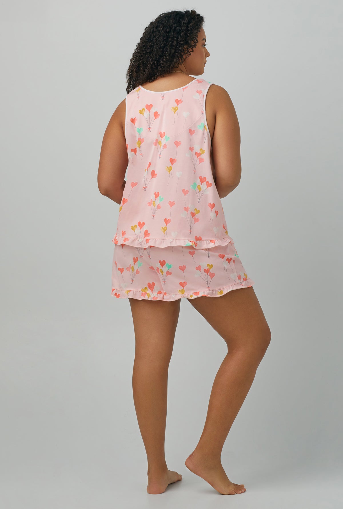 A lady wearing Tank Shorty Stretch Jersey PJ Set with Floating Hearts Ruffle print