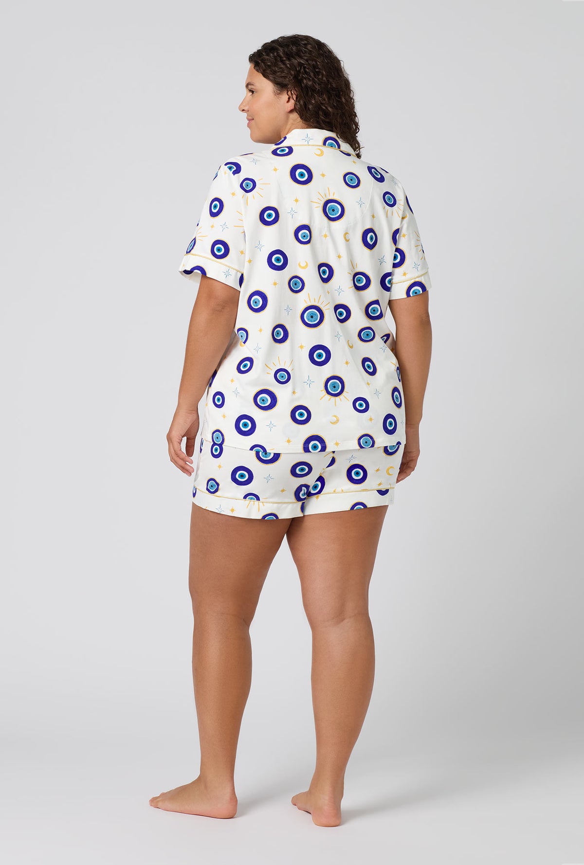 A Lady Wearing Plus Size Eyeconic Short Sleeve Classic Shorty Stretch Jersey Pj Set in a back view pose