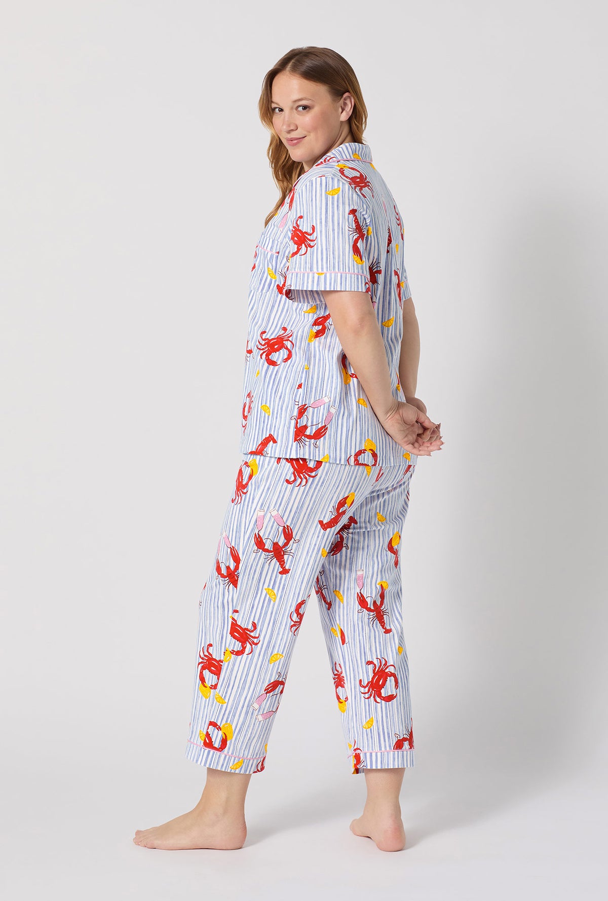 A lady wearing plus size Coastal Feast Short Sleeve Classic Stretch Jersey Cropped Pj Set back view