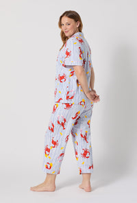 A lady wearing plus size Coastal Feast Short Sleeve Classic Stretch Jersey Cropped Pj Set back view