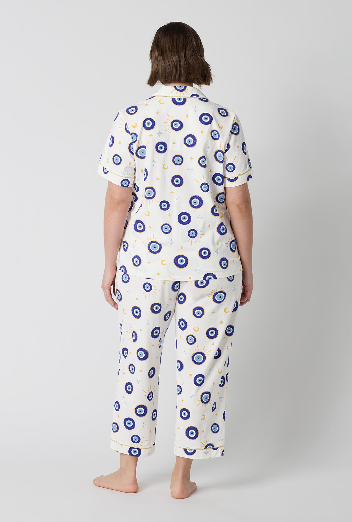 A Lady Wearing Plus Size Eyeconic Short Sleeve Classic Stretch Jersey Cropped Pj Set in a back view pose