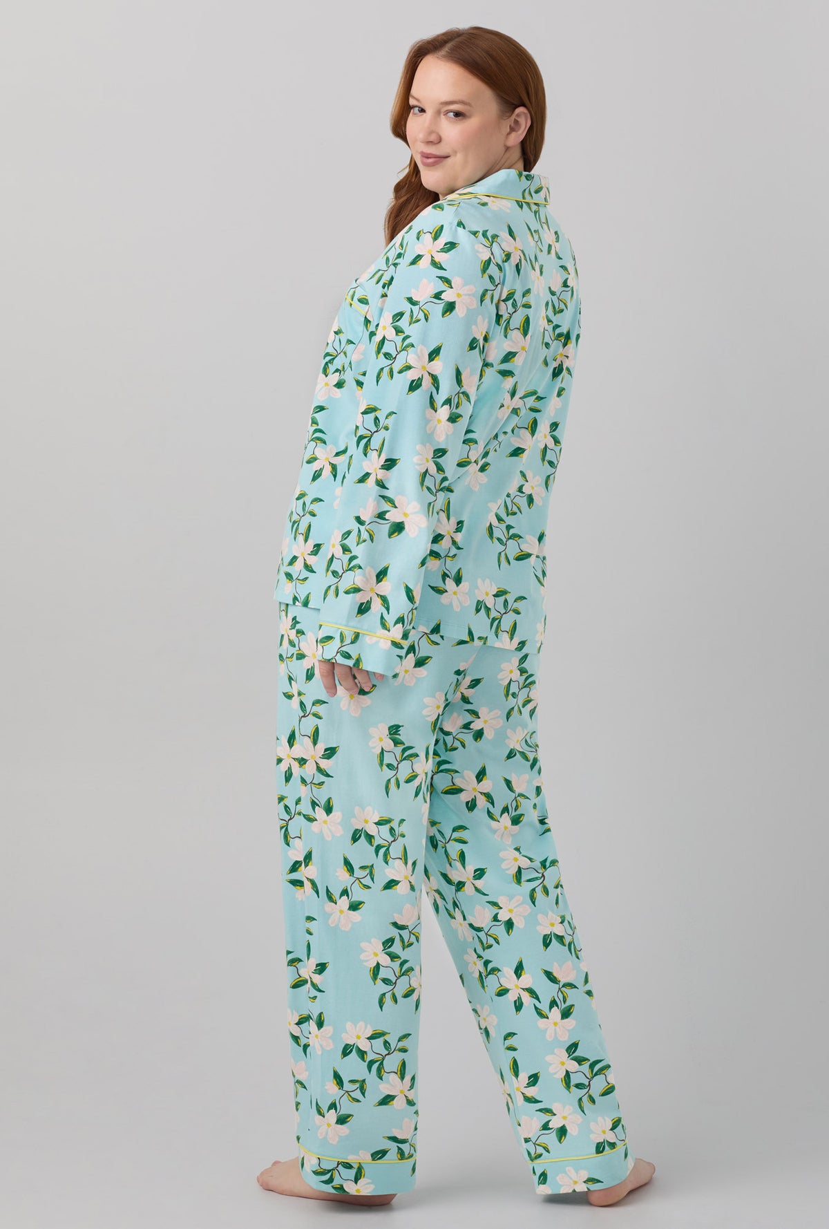 A lady wearing blue long sleeve classic stretch jersey pj set with belle blossoms print
