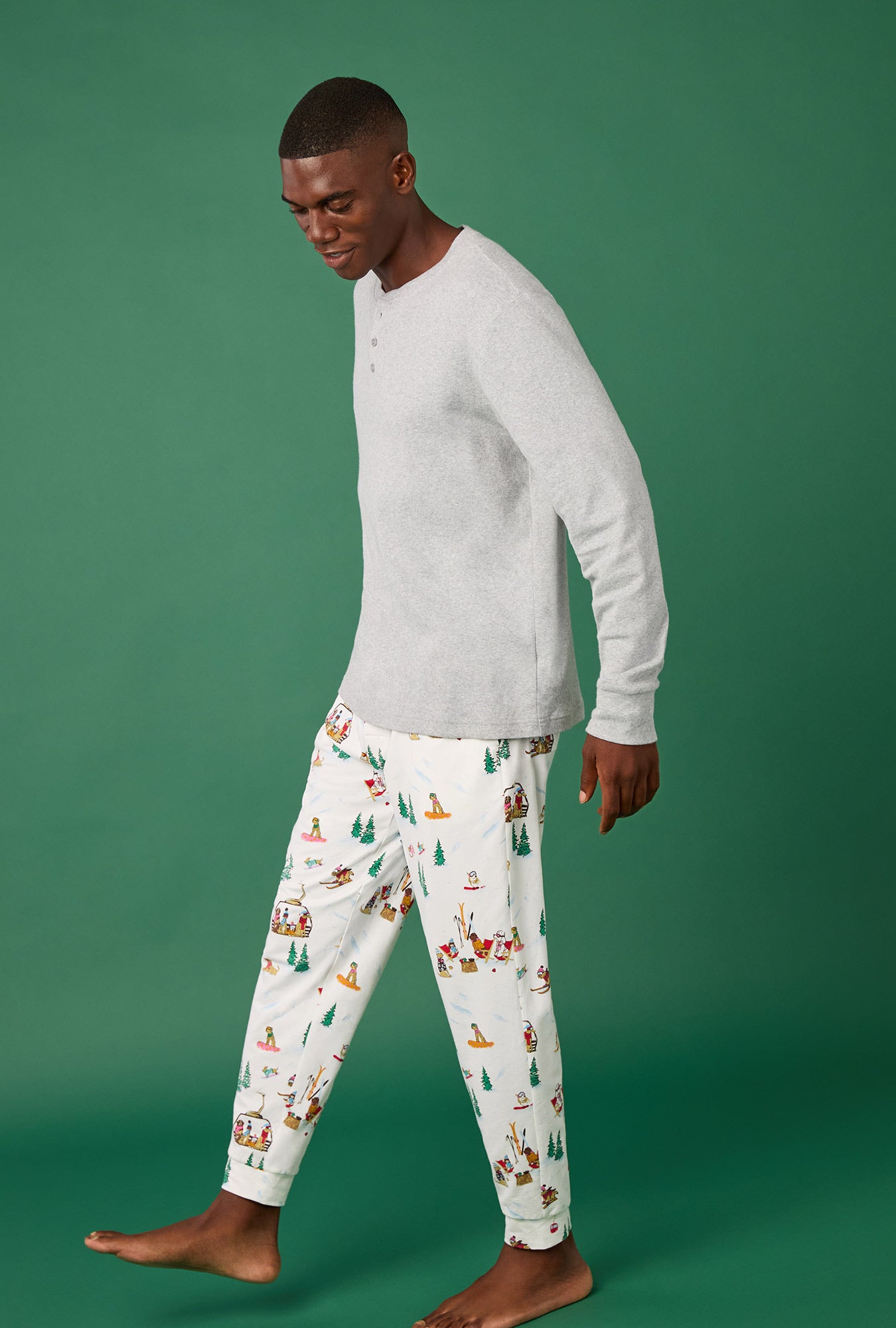 A man wearing Ski Pups Men's Long Sleeve Henley And Jogger Stretch Jersey Pj Set