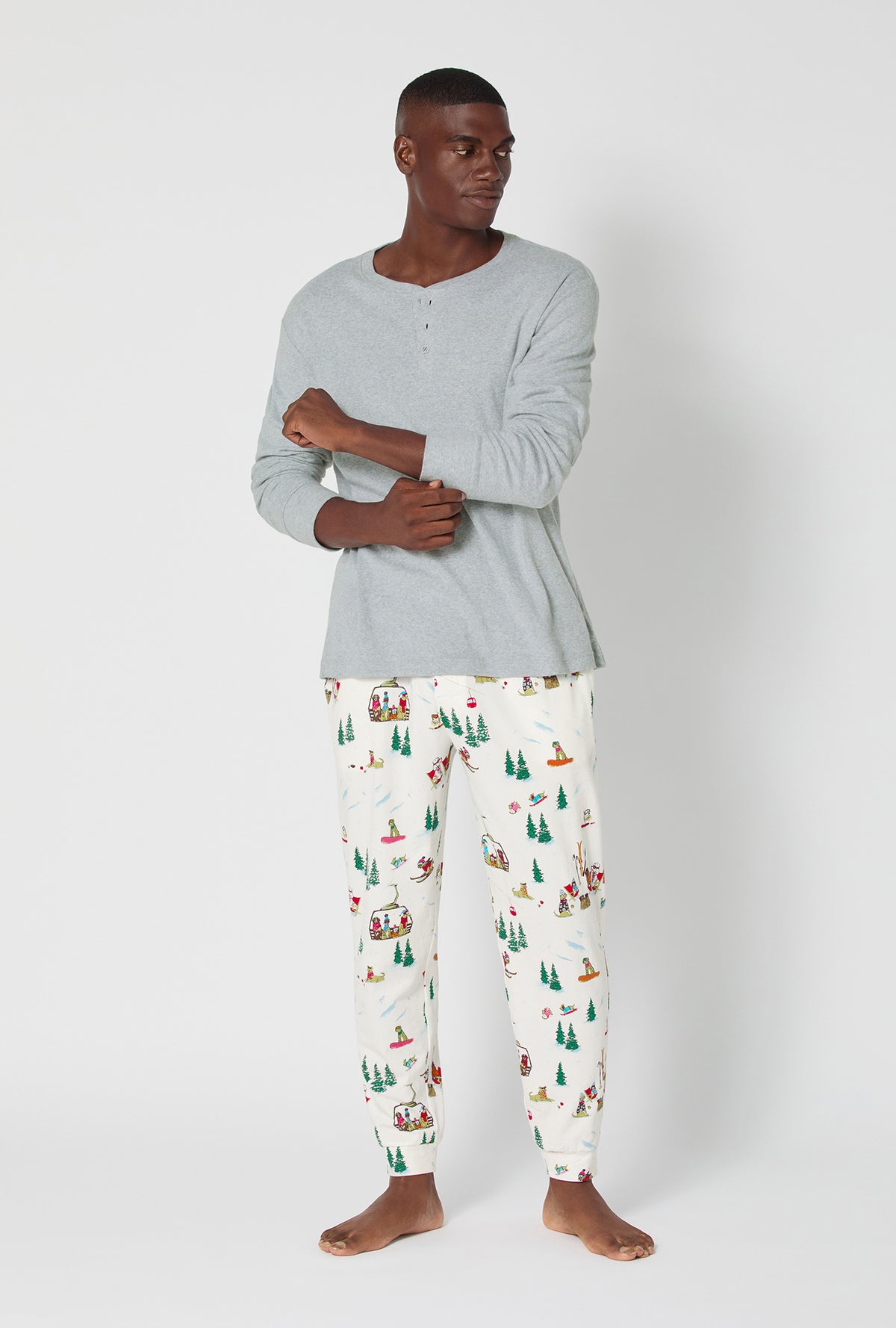 A man wearing Ski Pups Men&#39;s Long Sleeve Henley And Jogger Stretch Jersey Pj Set