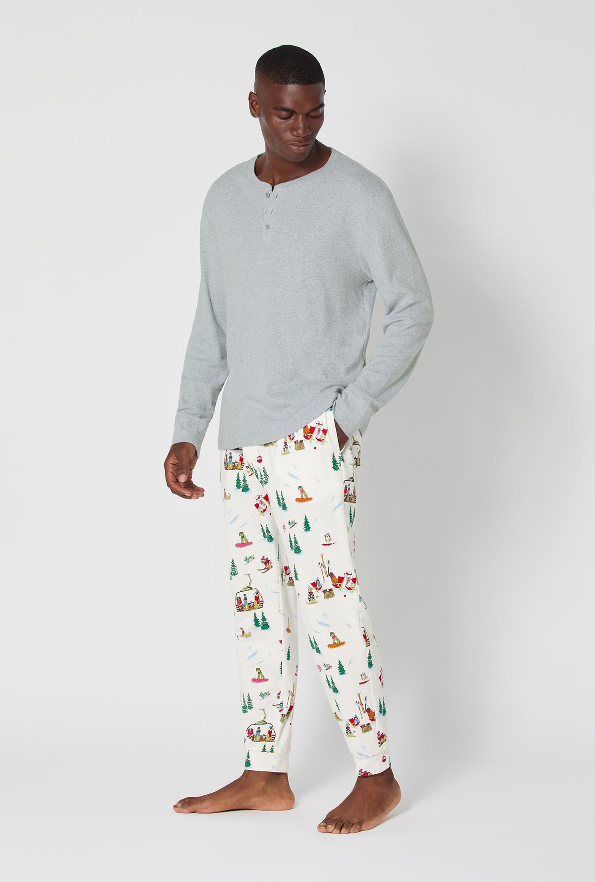 A man wearing Ski Pups Men&#39;s Long Sleeve Henley And Jogger Stretch Jersey Pj Set
