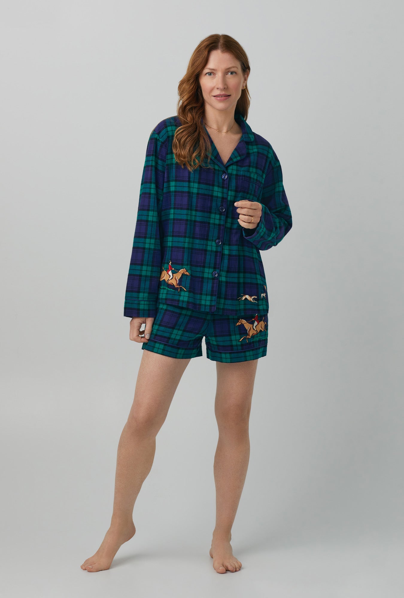 A lady wearing navy long sleeve classic shorty woven portuguese flannel pj set with highlander print.