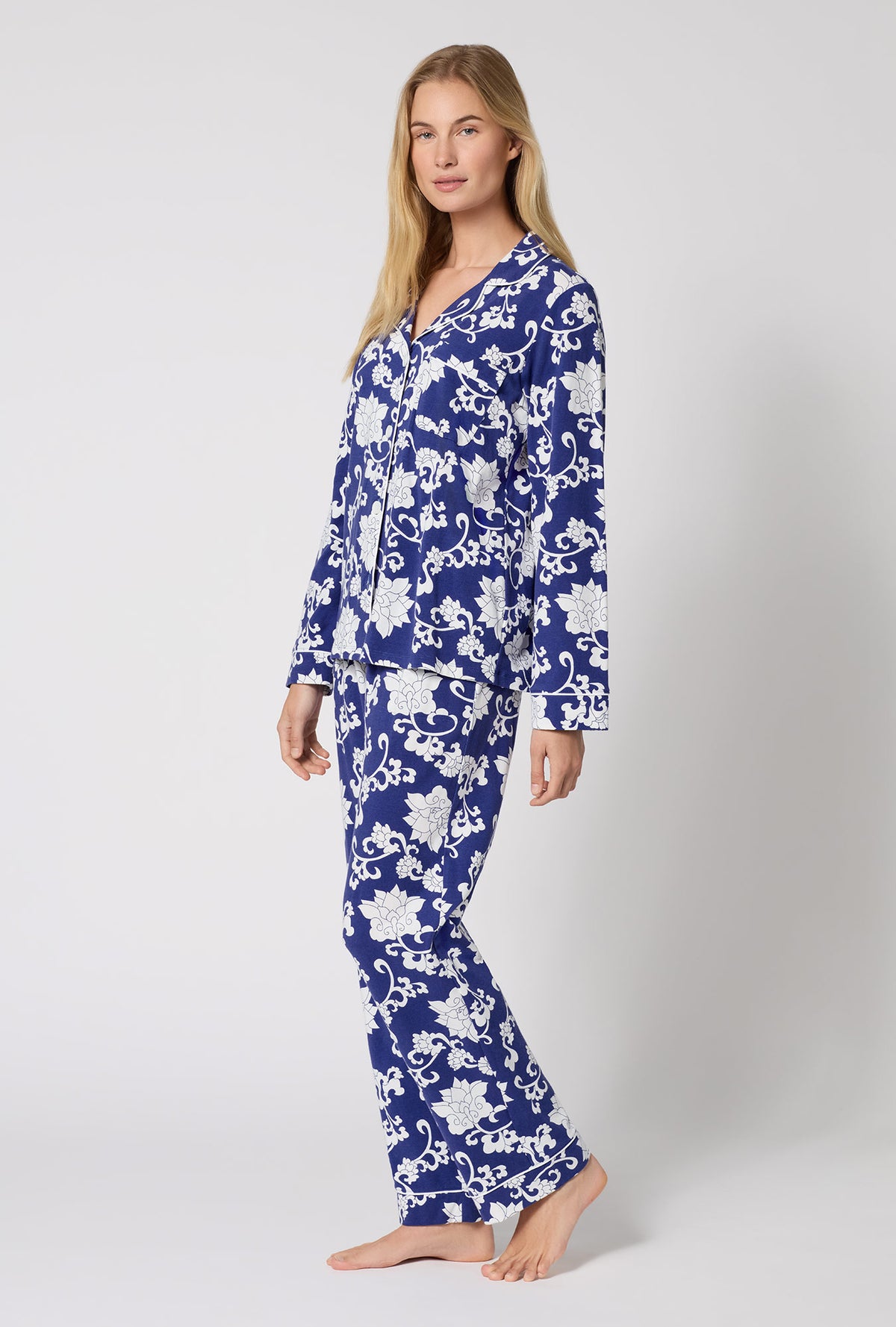 A Lady Wearing Dynasty Blue Long Sleeve Classic Stretch Jersey Pj Set in a side angled pose