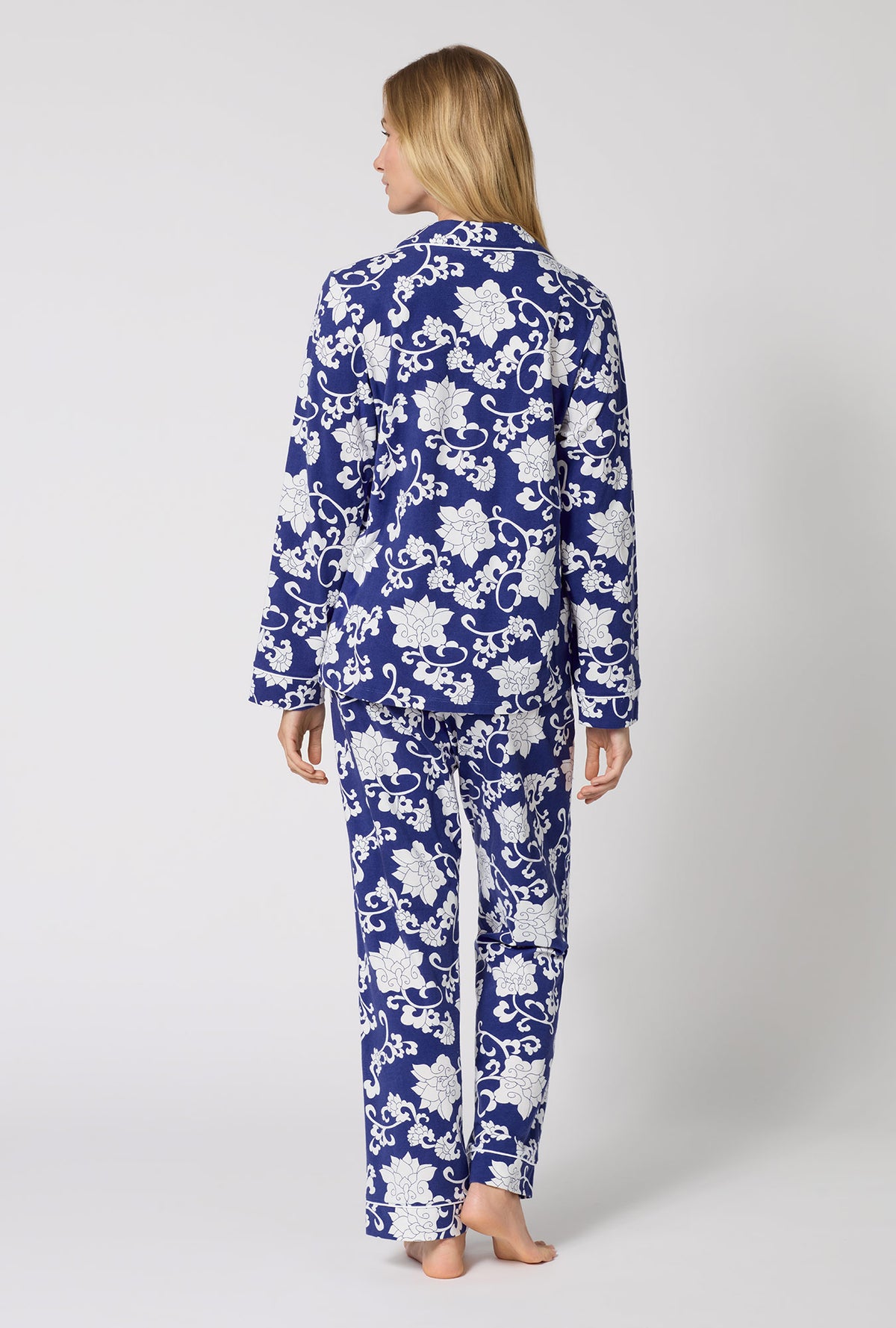 A Lady Wearing Dynasty Blue Long Sleeve Classic Stretch Jersey Pj Set in a back view pose