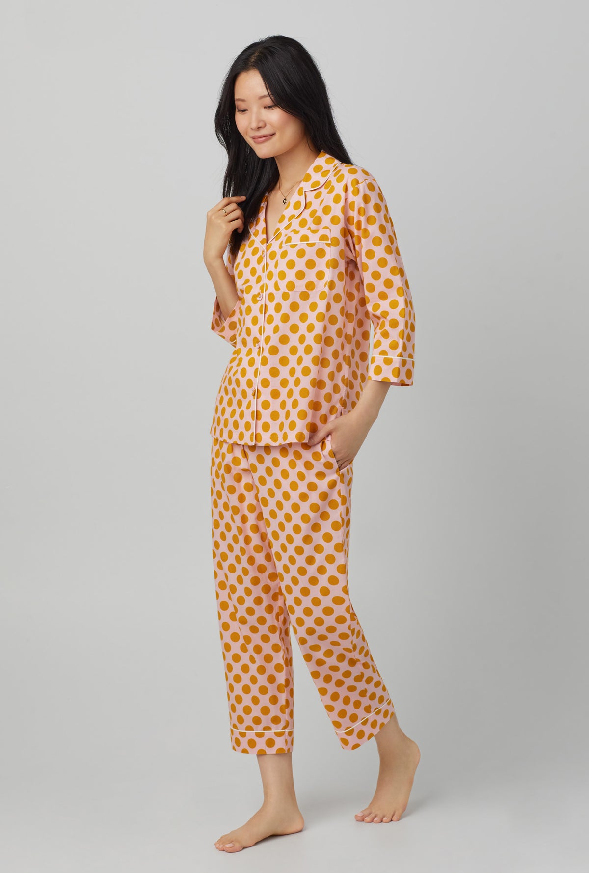 A lady wearing 3/4 sleeve classic cotton cropped pj set with call button print