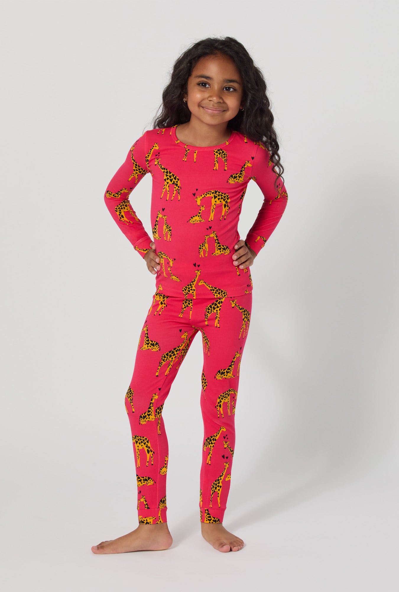 A girl wearing Giraffes In Love Long Sleeve Stretch Jersey Kids Pj Set