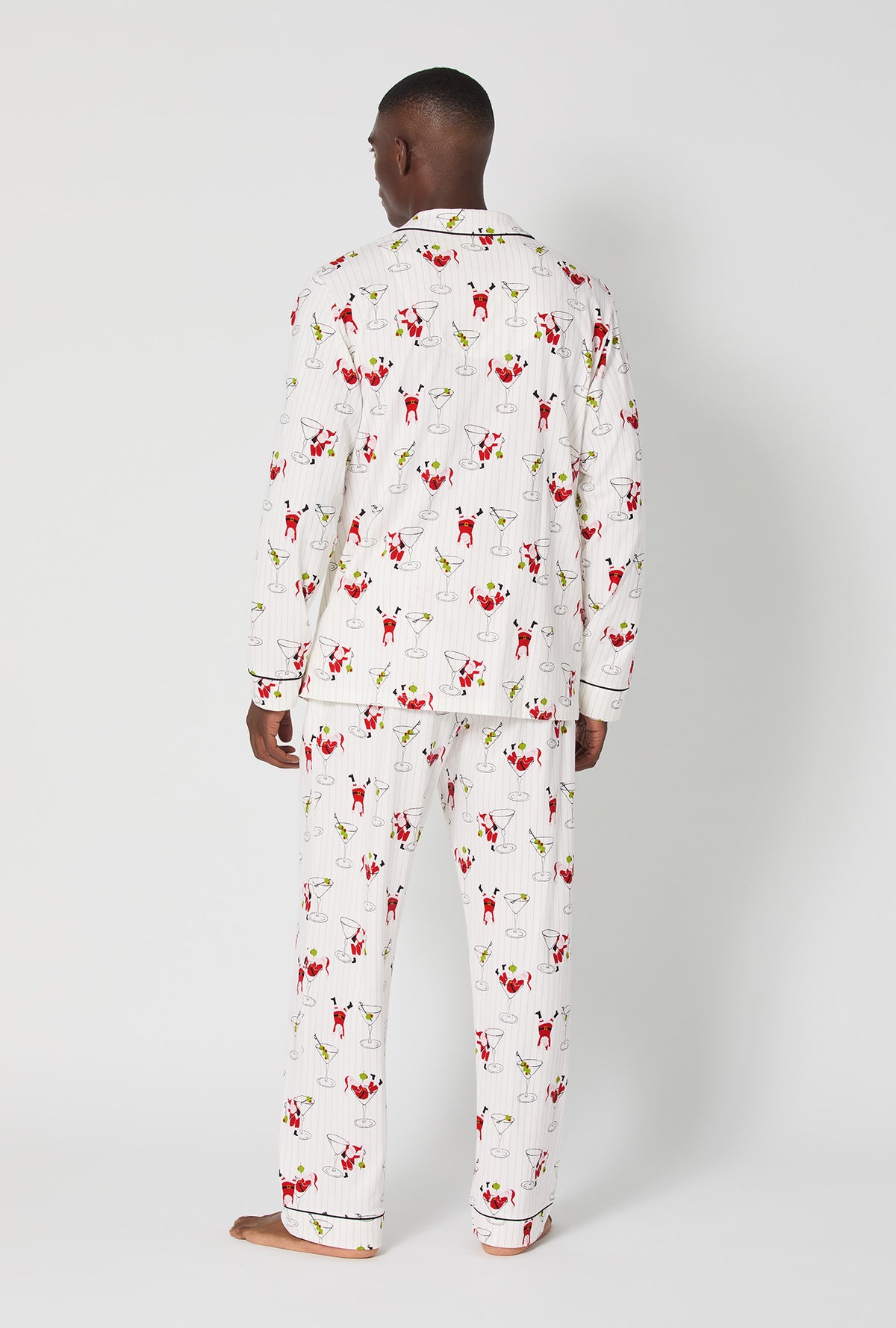 A man wearing Tipsy Santa Men&#39;s Long Sleeve Classic Stretch Jersey Pj Set
