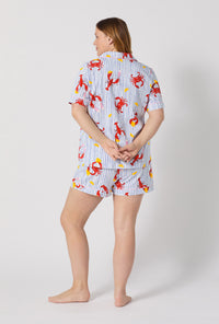 A lady wearing plus size Coastal Feast Short Sleeve Classic Shorty Stretch Jersey Pj Set back view