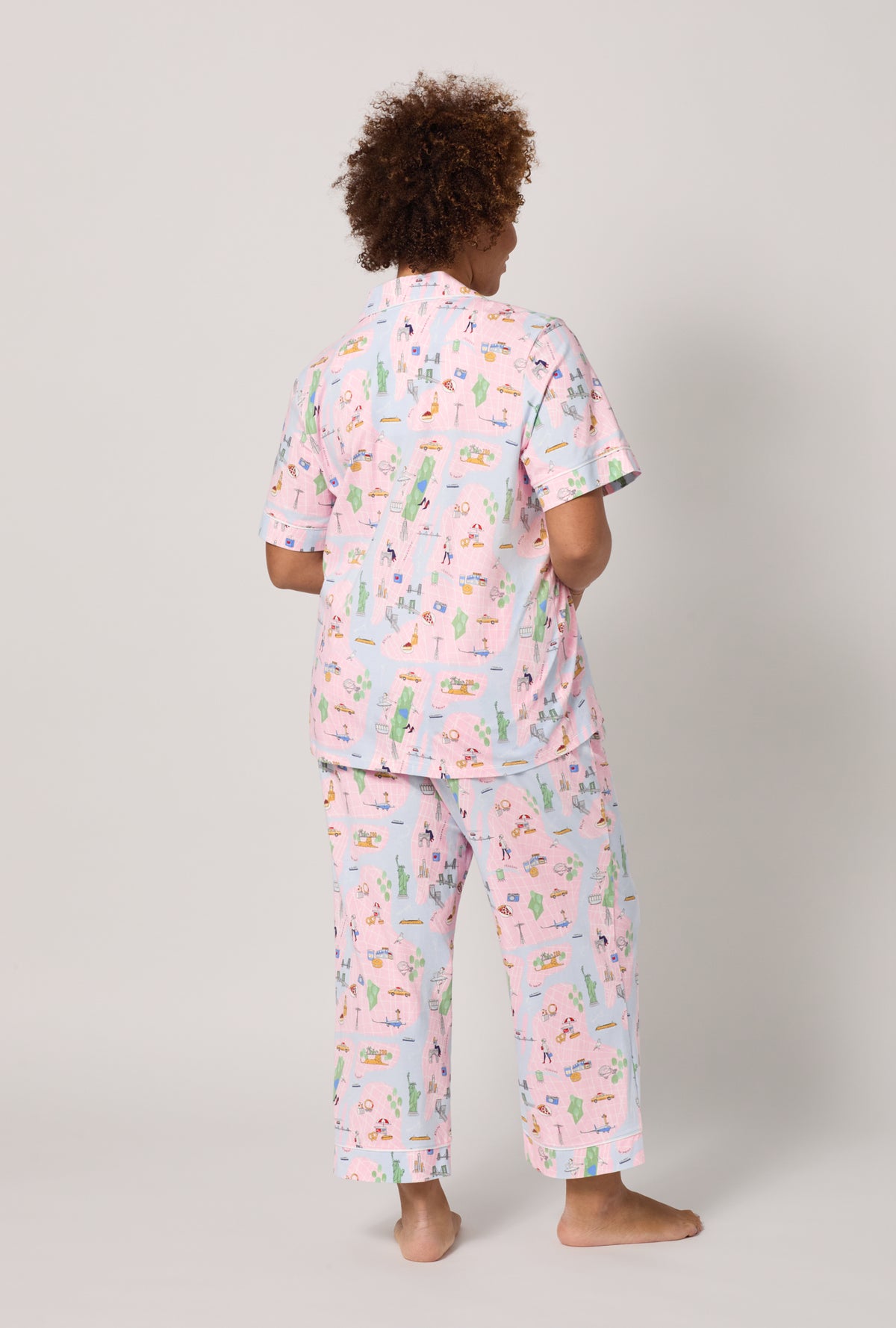A lady wearing plus size New York, New York Short Sleeve Classic Stretch Jersey Cropped Pj Set