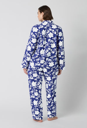 A Lady Wearing Plus Size Dynasty Blue Long Sleeve Classic Stretch Jersey Pj Set in a back view pose