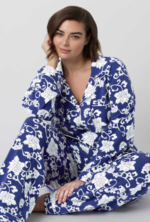 A Lady Wearing Plus Size Dynasty Blue Long Sleeve Classic Stretch Jersey Pj Set in a sitting pose