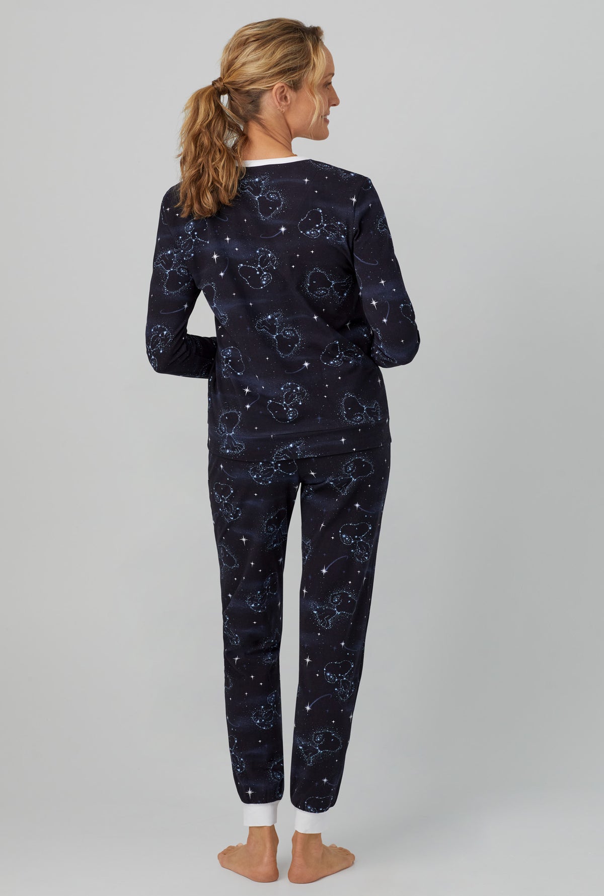 A lady wearing black  Long Sleeve Pullover Crew and Jogger Stretch Jersey PJ Set with Celestial Snoopy  print
