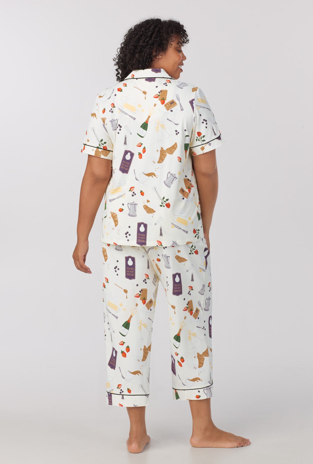 A lady wearing Short Sleeve Classic Stretch Jersey Cropped PJ Set with Breakfast In Bed print