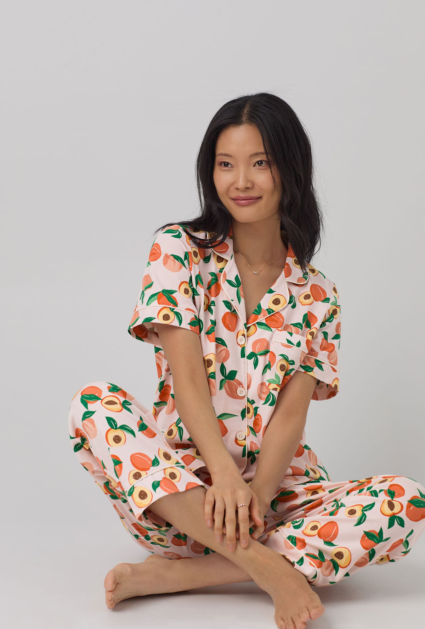 A lady wearing Short Sleeve Classic Stretch Jersey Cropped PJ Set with Peachy Keen print