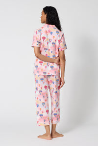 A Lady Wearing Serene Sunrise Short Sleeve Classic Stretch Jersey Cropped Pj Set in a back view pose