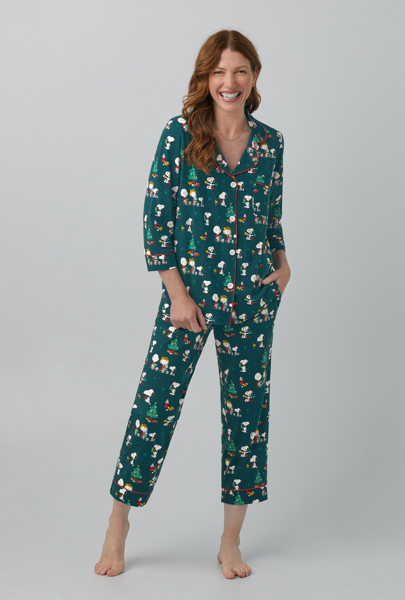 A lady wearing green 3/4 Sleeve Classic Stretch Jersey Cropped  PJ Set with Snoopy's Cocoa print