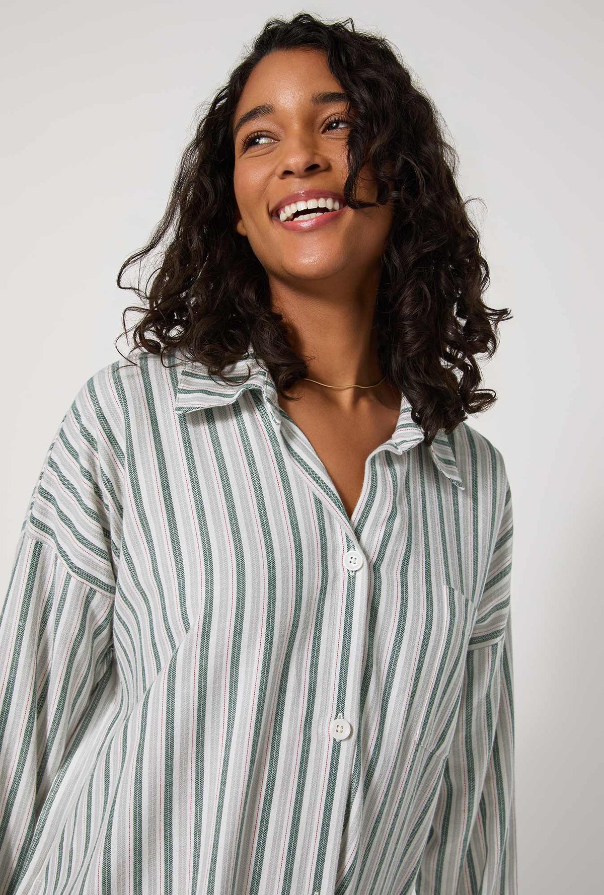 A lady wearing Peppermint Stripe High Low Woven Portuguese Flannel Boyfriend Shirt