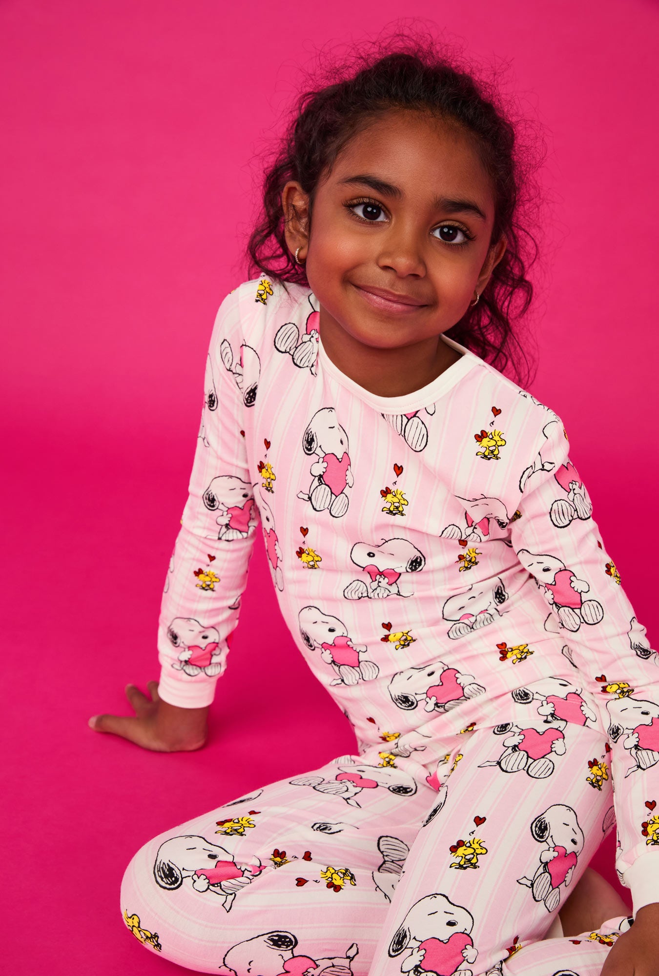 A girl wearing Snoopy's Valentine Long Sleeve Stretch Jersey Kids Pj Set