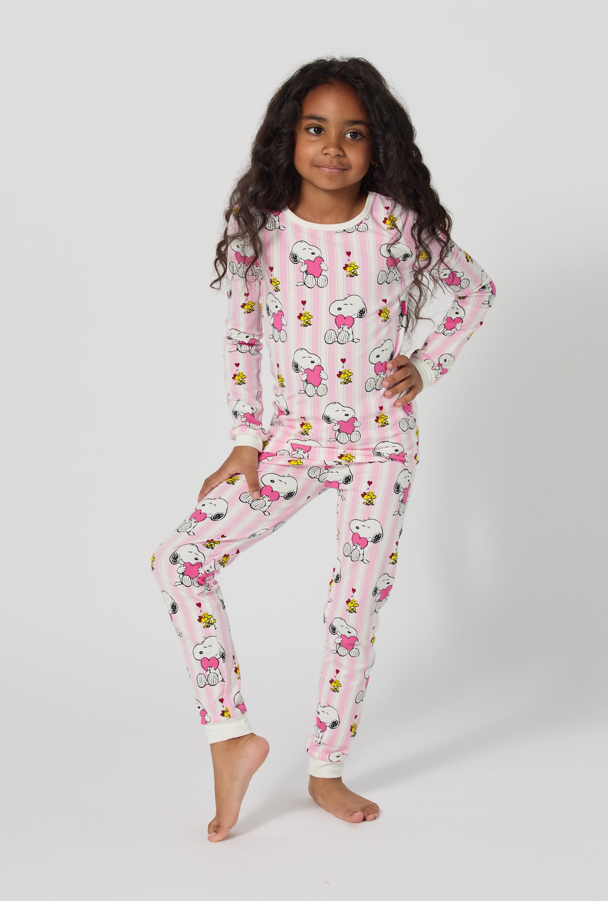 A girl wearing Snoopy's Valentine Long Sleeve Stretch Jersey Kids Pj Set