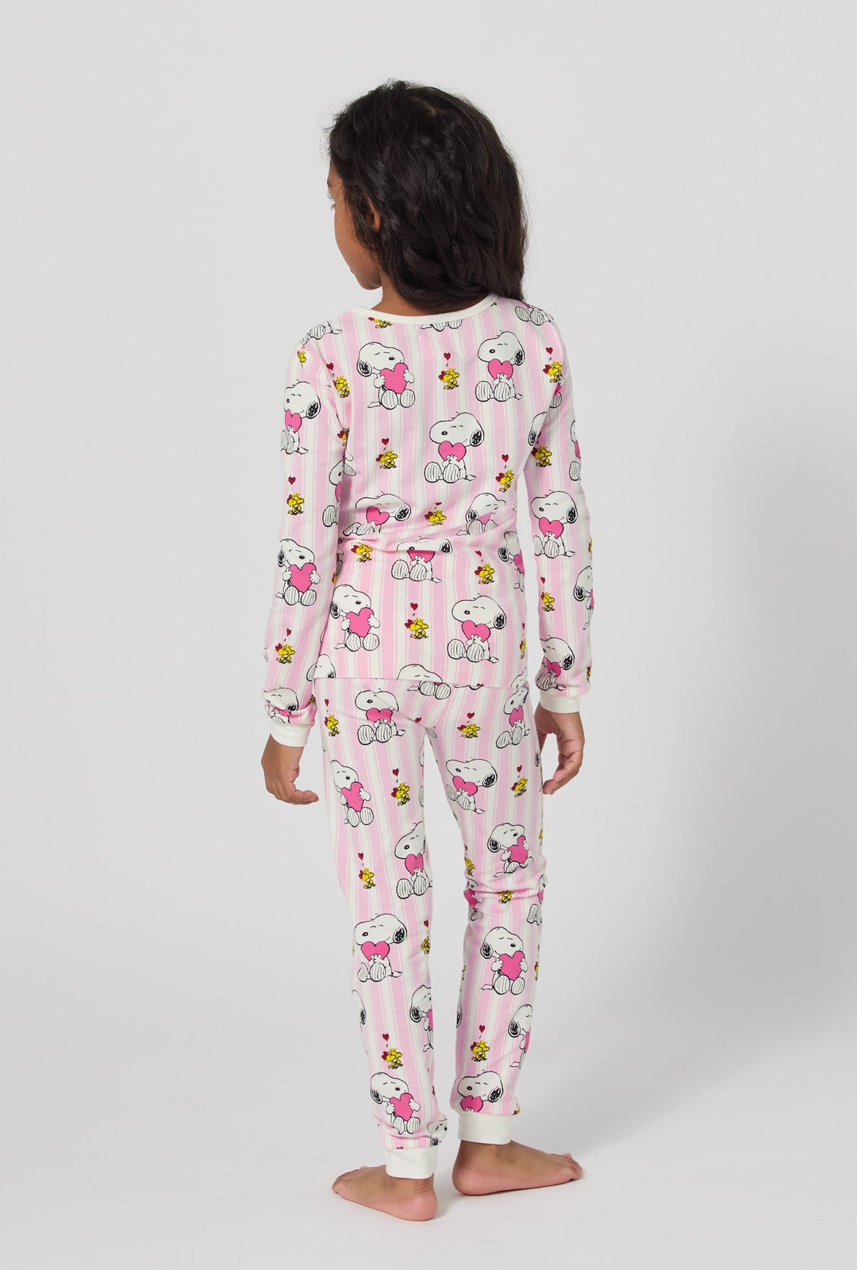 A girl wearing Snoopy's Valentine Long Sleeve Stretch Jersey Kids Pj Set