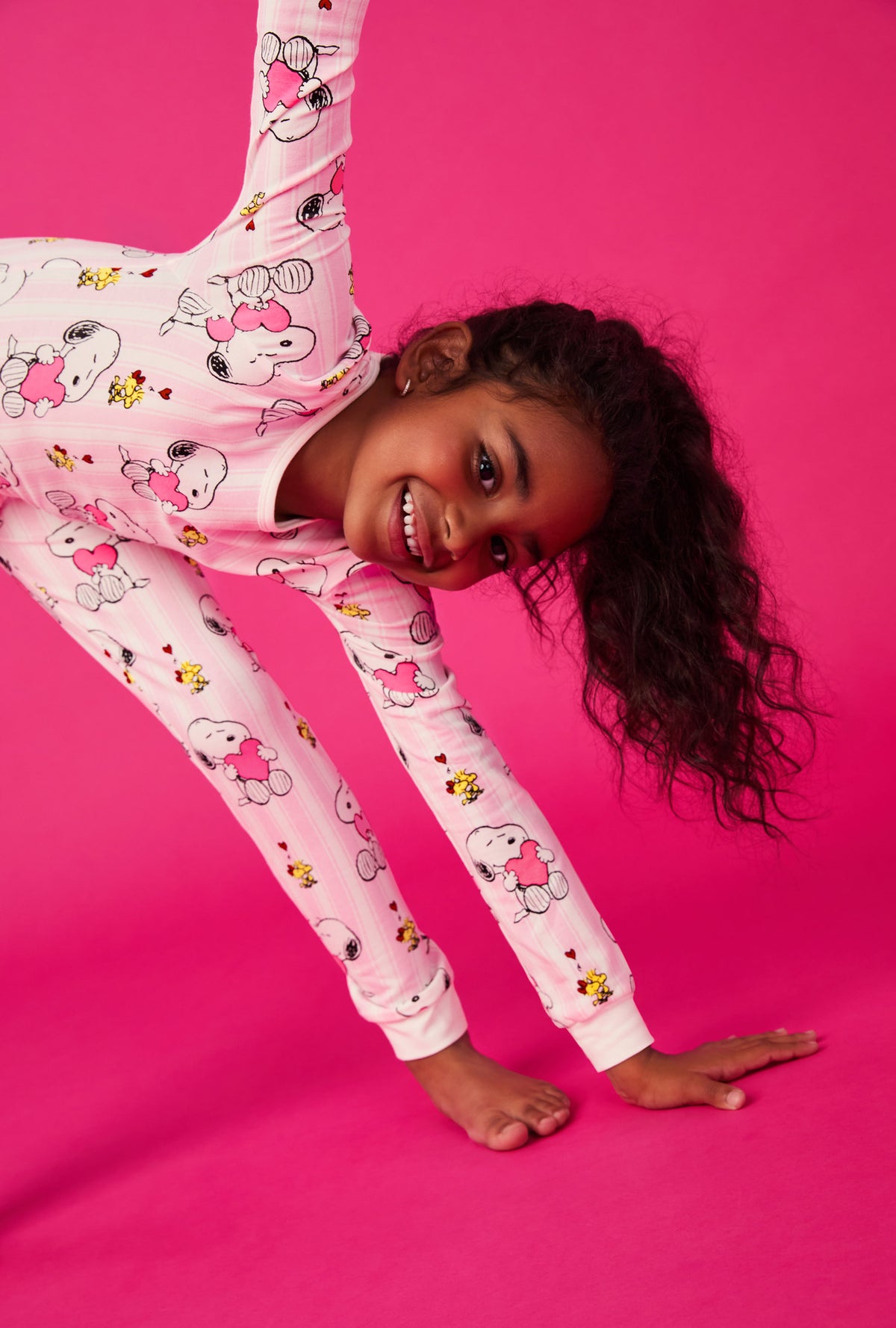 A girl wearing Snoopy's Valentine Long Sleeve Stretch Jersey Kids Pj Set