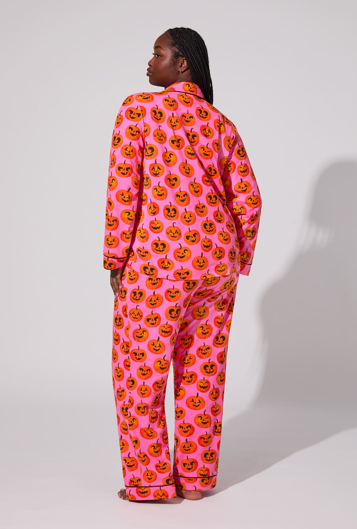 A lady wearing Jolly Jack-O-Lanterns Long Sleeve Classic Stretch Jersey PJ Set